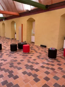 aménagement de l'abbaye de montivilliers : poufs lounge, présentoirs, chaises lounge, banque d'accueil, restauration