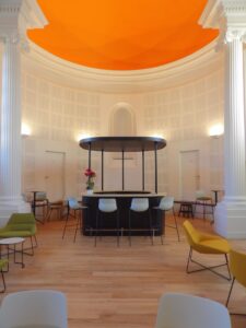 aménagement d'espaces et agencement de mobilier pour le Collegium de Bayeux : table de réunion, chaises empilables, sièges de conférence, canapé lounge, bar central