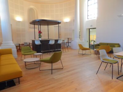aménagement d'espaces et agencement de mobilier pour le Collegium de Bayeux : table de réunion, chaises empilables, sièges de conférence, canapé lounge, bar central